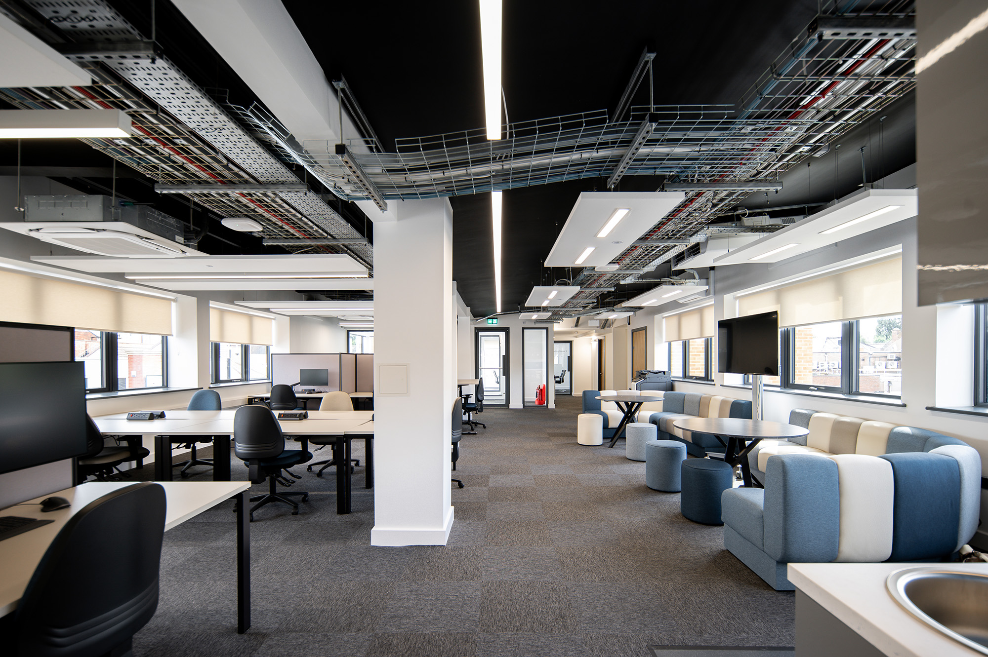 First floor of Bloxwich Launchpad showing blue sofas and desks in an open plan working space