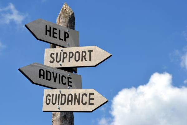 Wooden signpost for advice, support and information