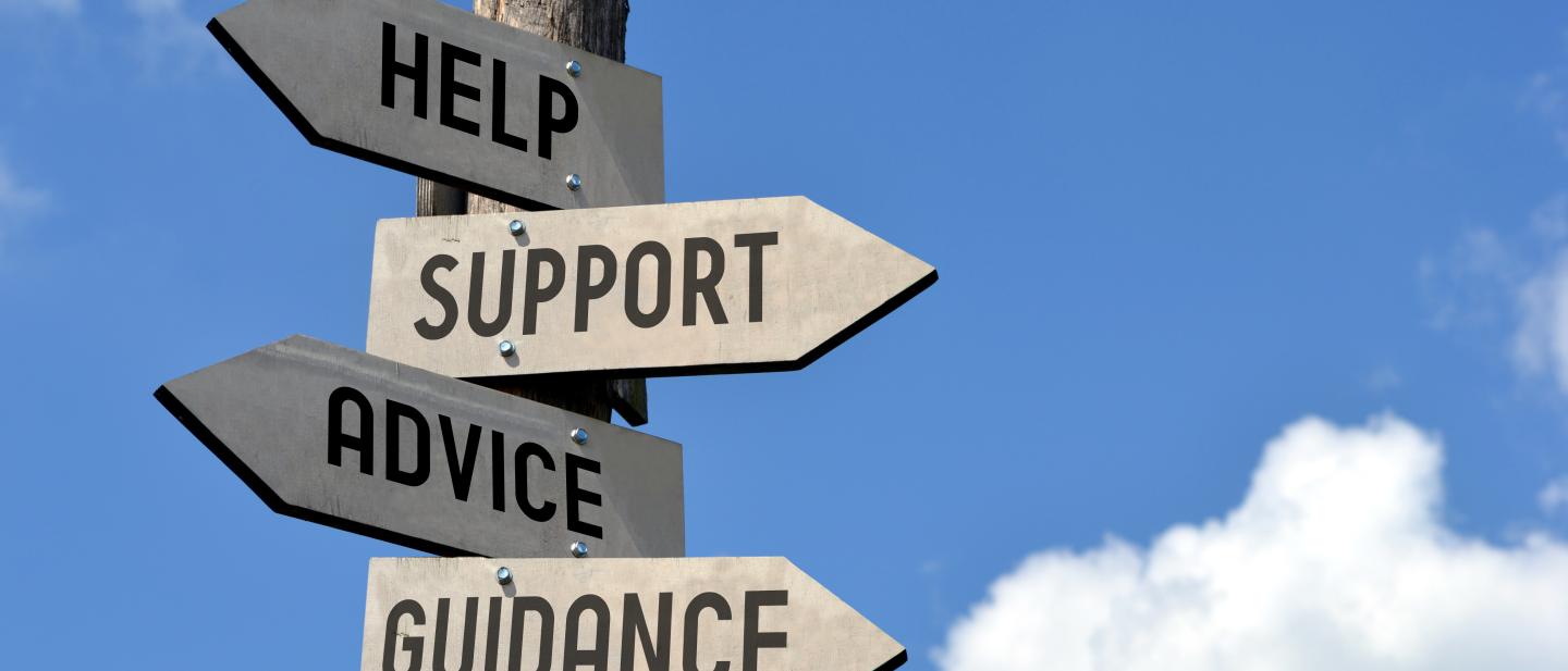Wooden signpost for advice, support and information