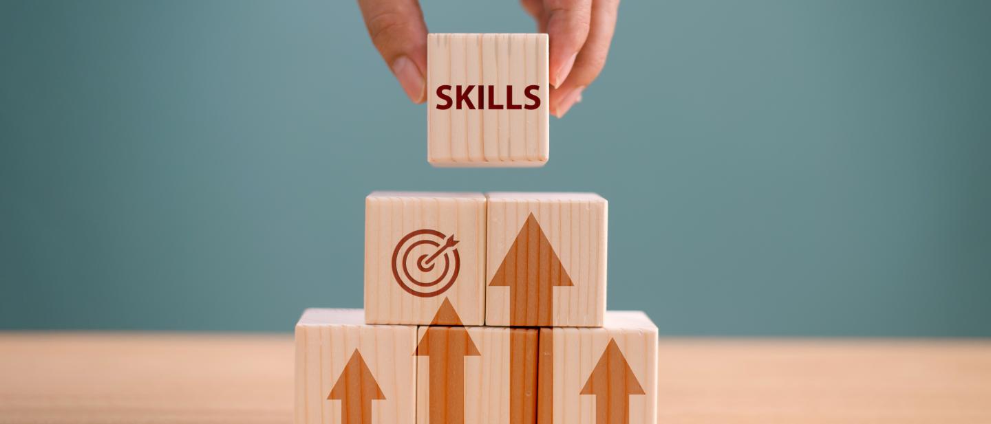 A small pile of wooden blocks with the word "skills" at the top
